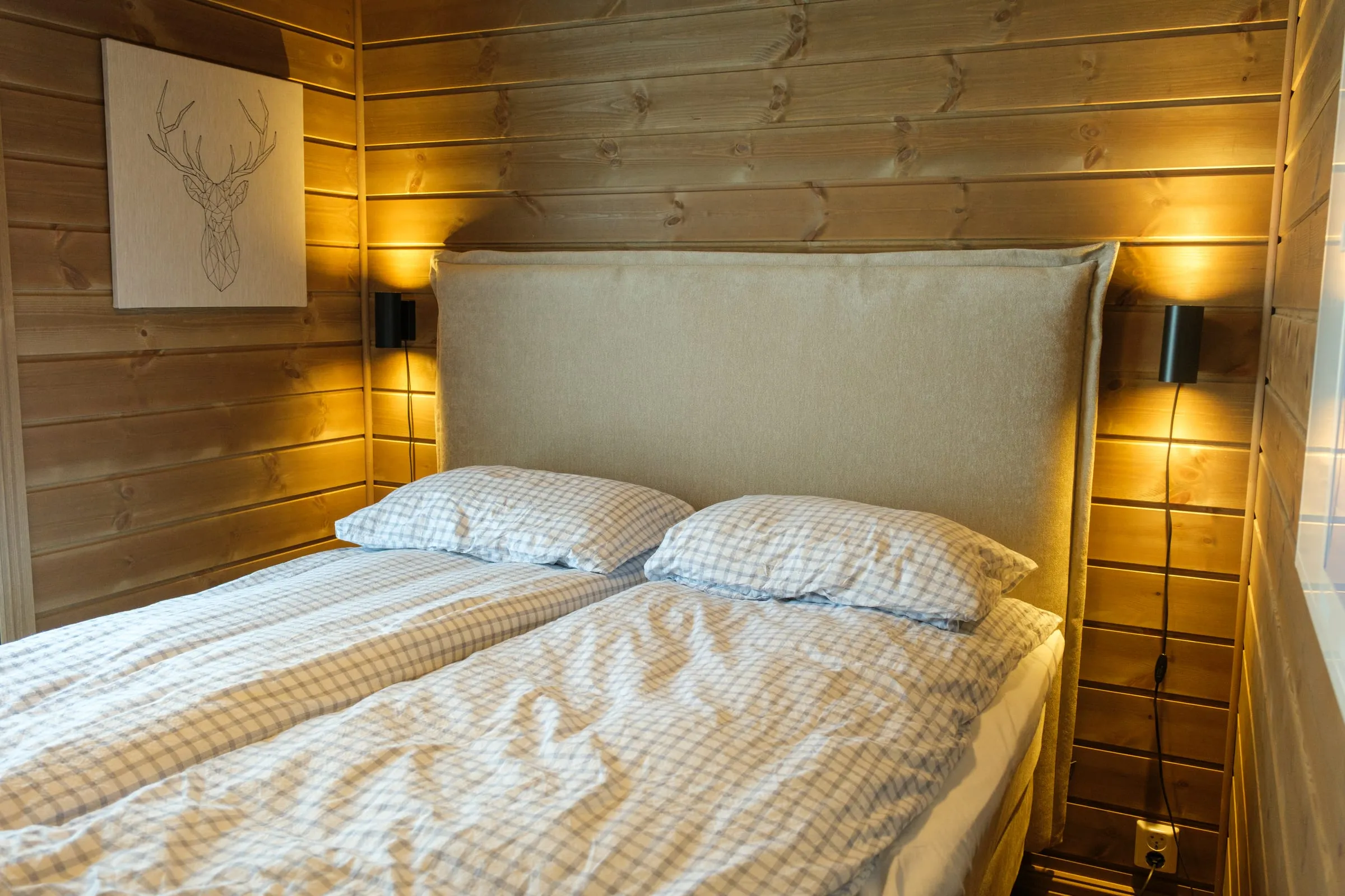 Queen bedroom with checked linen and soft evening light