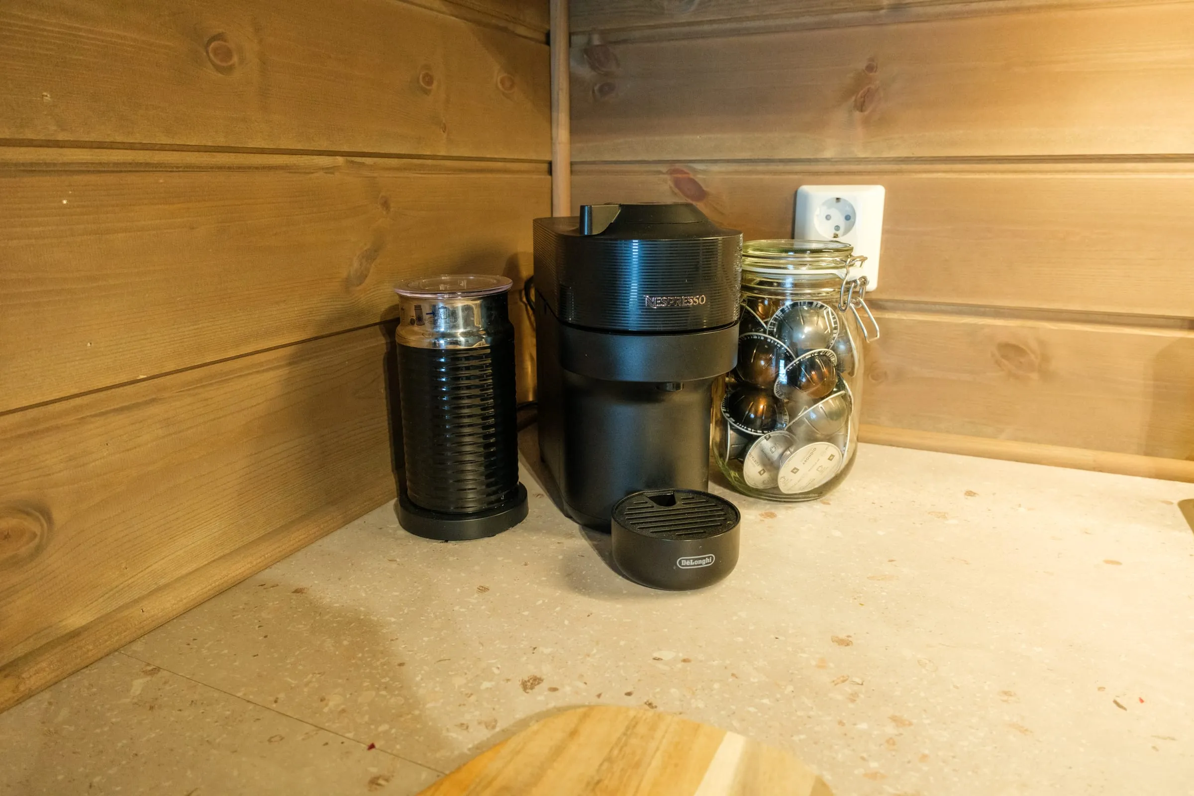 Coffee corner with a Nespresso machine and milk frother on the worktop